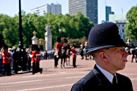 I had been in London for all of about two hours (time enough to get to my hotel and and have a shower) when I decided to go for a walk in Green Park towards the palace. When I got there I found huge security and vast groups of tourists. Seems that the horse guards were rehearsing for something big in the next week. Despite the security there was an almost festival atmosphere with tourists (myself included) taking an unexpected chance for a sneak preview. Even the police, while watchful seemed in the mood. Except for this guy who seemed to be able tune out everything except his job. I liked the juxtaposition of him and the pageantry behind.
