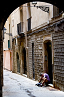 Wandering the streets of the old town in Barcelona when I looked down a side street and caught this image. Didn't want to stop as I thought he may notice and react. At first the image (to me) conjures ideas of loneliness and loss, A person alone in a city that is teeming with life. However he had actually stopped to eat his lunch, not sure if he was a tourist or a local. I liked the image. Technically I had little to do with this picture, the camera and lens did all the work. I was walking down one of the very busy tourist haunts of the old town, saw this guy, lifted the camera to my eye and snapped without stopping walking. Especially for street photography I think you have to have a lot of faith in the cameras systems and worry about composition. At leat in this case it seemed to work.