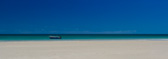 Treking along the beach with friends to look at some jetty ruins and we all noticed this lone boat moored nearby. I could resisit cropping the image to a broad panorama.