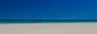 Treking along the beach with friends to look at some jetty ruins and we all noticed this lone boat moored nearby. I could resisit cropping the image to a broad panorama.